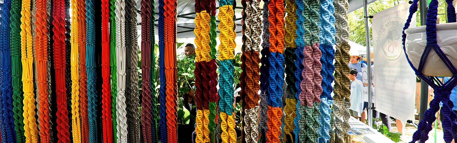 Some colorful handcrafted vintage-style macrame hangers made by Knotty Nanna.
