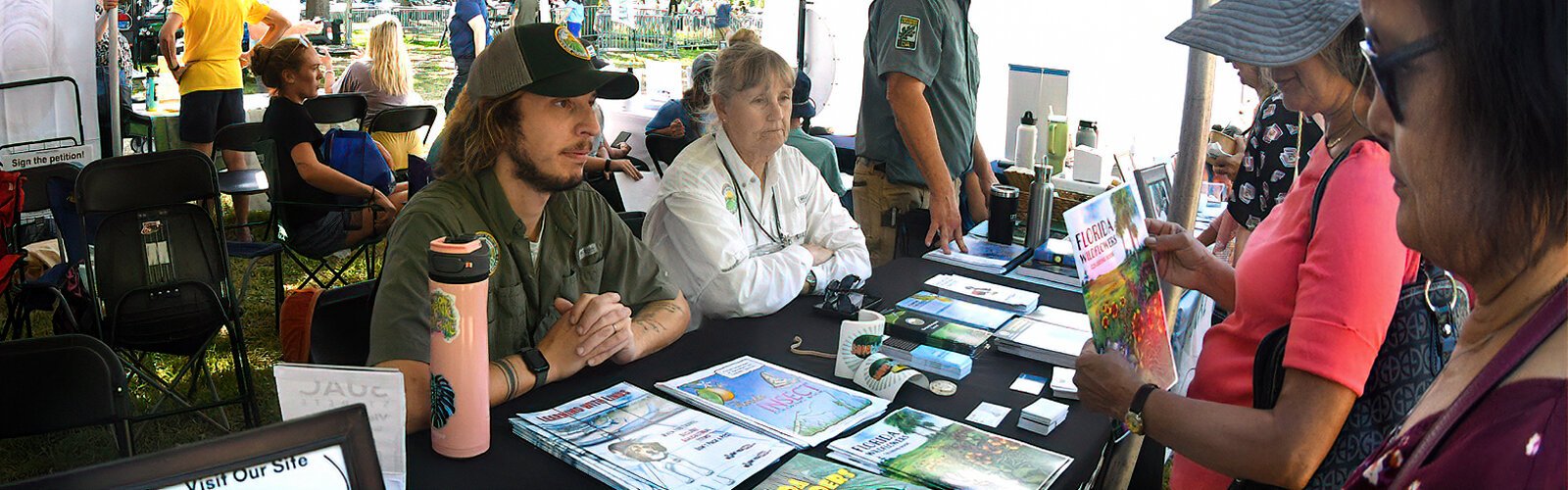 Grayson Grume and Bobbe Rose of the Florida Department of Agriculture are ready to answer questions from visitors at the Local Environmental Groups tent.