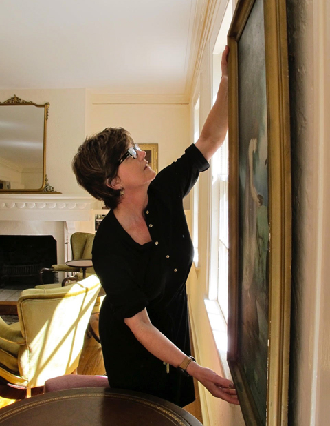 Kathy Gibson of Arthouse3 installing work in a client's home.