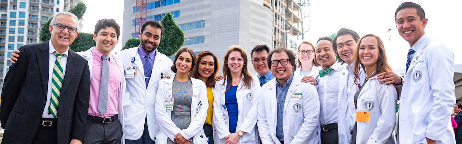 Dr. Panos Vasiloudes poses with medical students at the November topping off-ceremony for the new USF Health Morsani College of Medicine and Heart Institute.