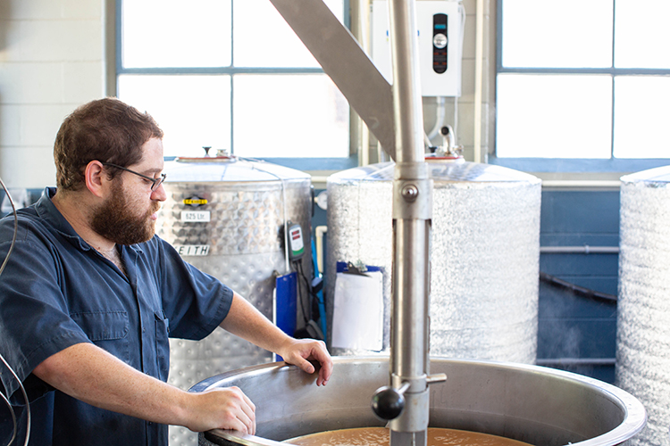 Aaron Barth, head brewer, looks over his batch at Clearwater Brewing Company.