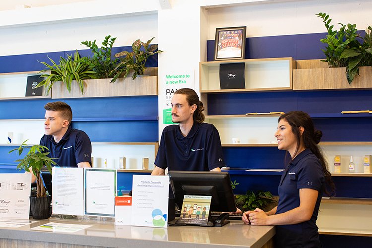 Graham Johnson, Natalia Lopez, and Andrew Squires assist customers at Liberty Health Sciences medical marijuana dispensary in St. Pete.