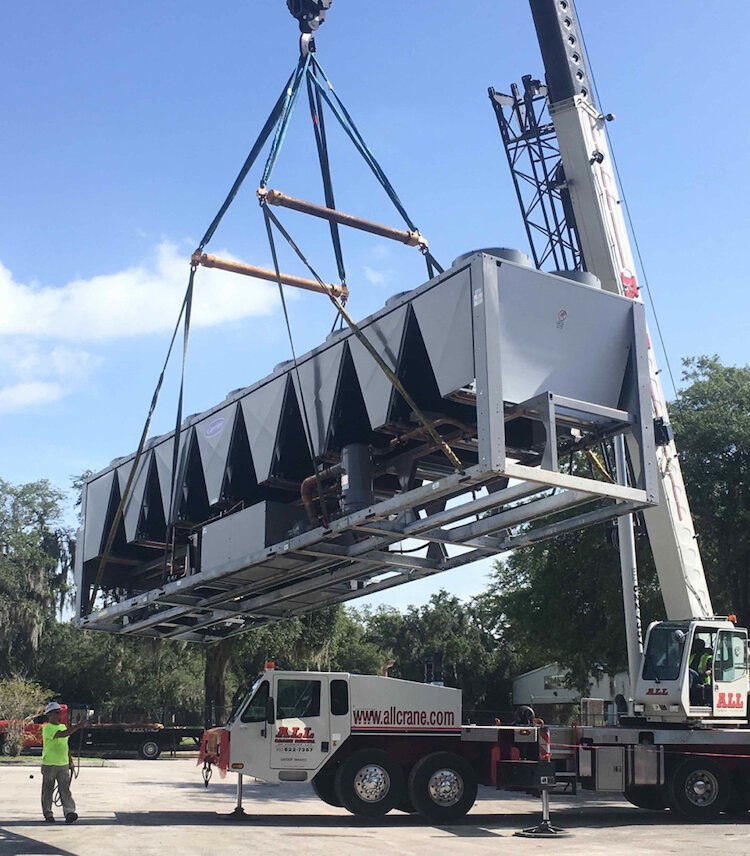 A crane lifts a new air handler at Walden Lake Elementary in Plant City.