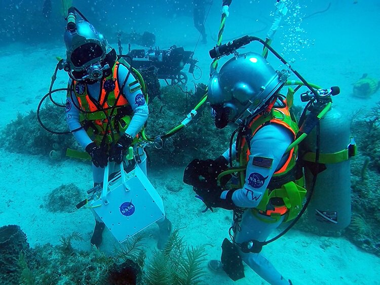 Researchers Csilla Ari D’Agostino and Samantha Cristoforetti leave the Aquarius habitat.