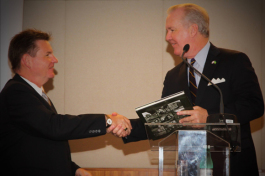 Mayor Bob Buckhorn gives a gift to U.S. Consul General Dennis Hankins