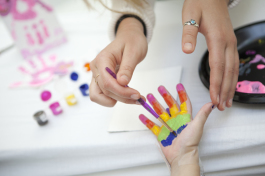 Abby Paterson paints St Joseph's patient Reagan Kelly's hand during an art therapy session at the ho