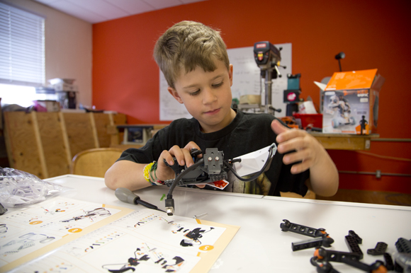 Aaron Ryley, 8, builds a robot at Tampa Hackerspace during Kid's Open Make Day. 