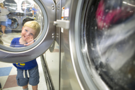 Archer Ayers, 1, plays at a Dunedin Coin Laundry with dad Dale close by. - Julie Branaman