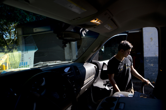 Joshua Colon works on a customer's car at Prime Time Car Care. 