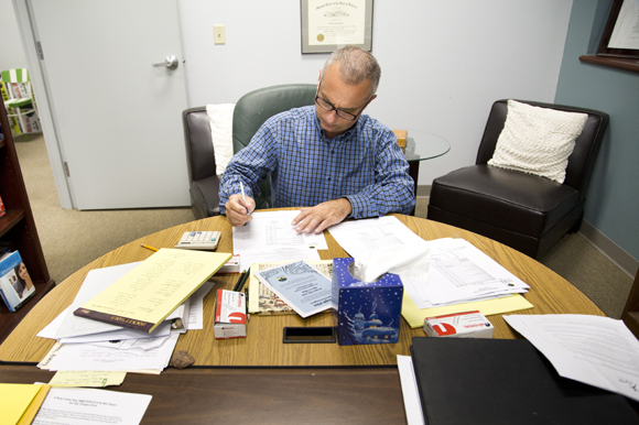 Lincoln Tamayo, Head of School at Academy Prep Center of Tampa, works at his desk. 