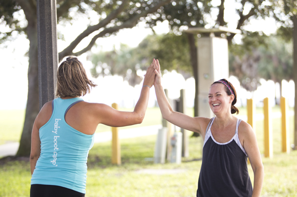 Christie Bruner and student Shelli Amow hi-five during Baby Boot Camp at Vinoy Park.  