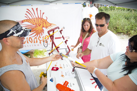 Guy Harvey Outpost Lionfish Safari participants check out the Lionfish Striker pole spear. 