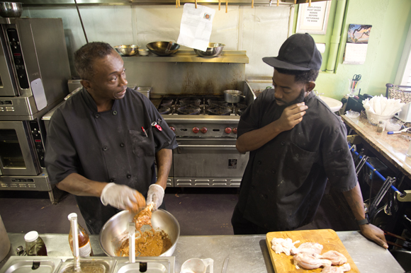 Chief's Creole Cafe Chef Carl McClellan shows Lorenza Jackson a recipe. 