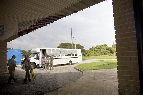 Participants board the bus at Wholesome Church