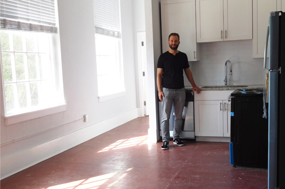 Michael Mincberg, president of Sight Real Estate, in a new kitchen at Euclid School apartments.