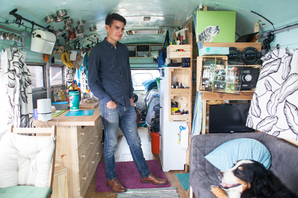Justin Florian inside a converted bus named Biggie Bus that cost under $10,000 to purchase and renovate.