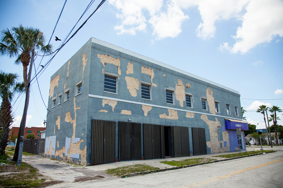 Exposed brick peers through blue painted exterior at the future home to retail and office sites in up-and-coming West Tampa.