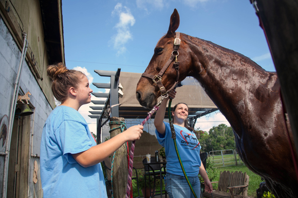 Hannah Hultgren and Bridget Bosch care for Shade, who was rescued at a Pennsylvania auction.