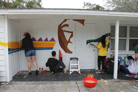 Volunteers work to improve the neighborhood at this year's Paint the Town event.
