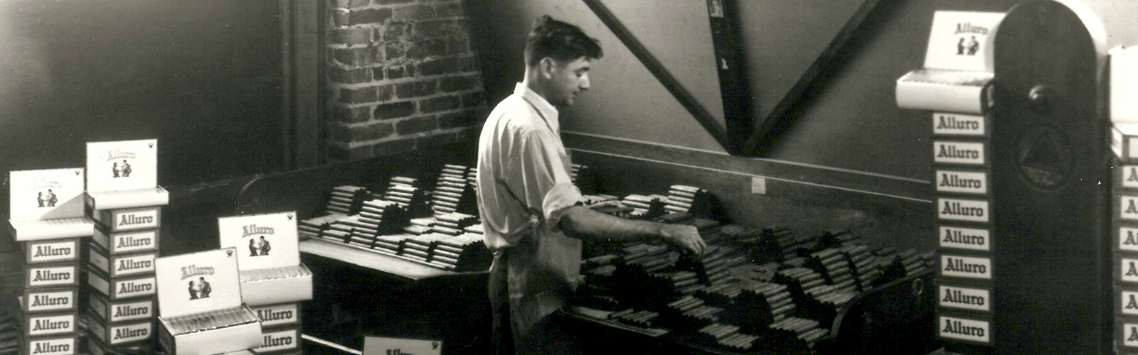 Interior of the Santaella cigar factory showing a worker boxing cigars in 1935.