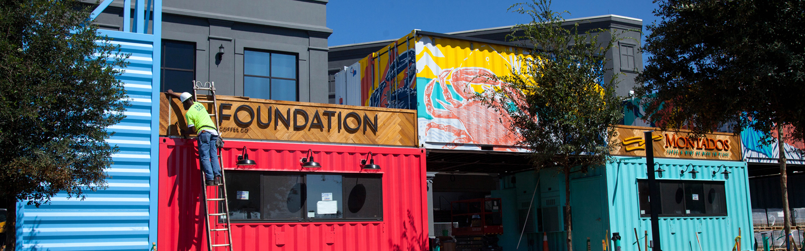 Restaurants inside eclectic shipping containers at Sparkman Wharf in the Channelside District.
