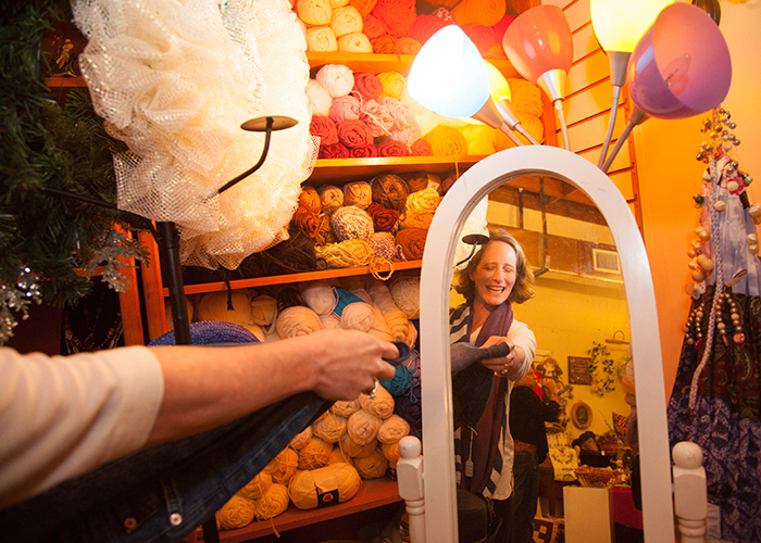 Meagan Heller looks through colorful Christmas crafts at the Red Tent Market storefront in St. Pete.