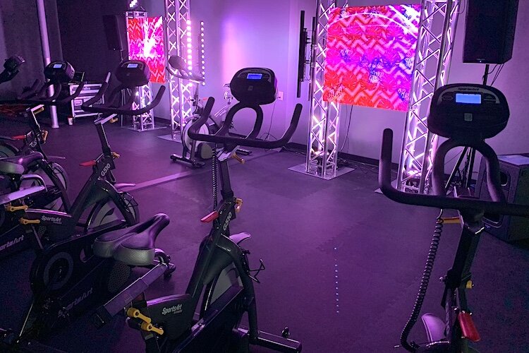 Creative lights and music create different moods for spinning classes.