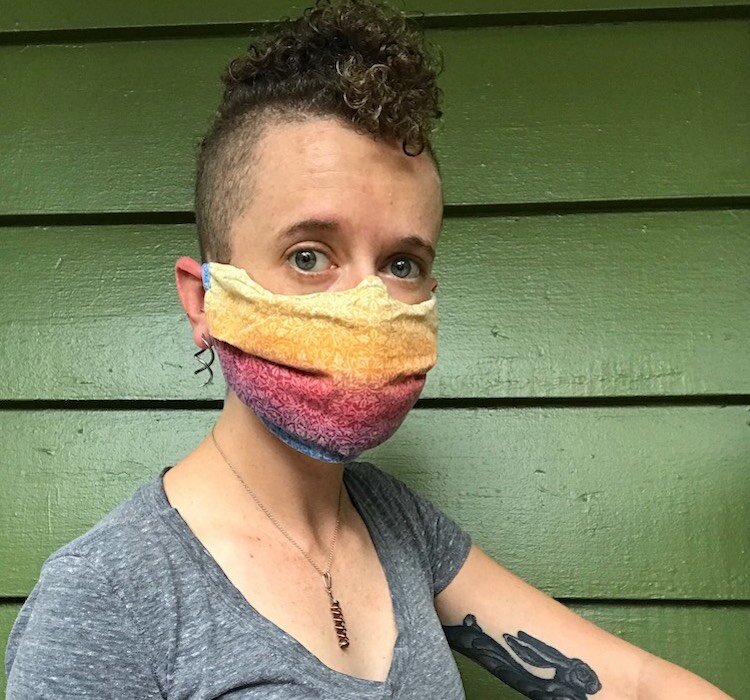 83 Degrees writer Jessi Smith demonstrates the proper nose fit and coverage for a homemade mask, this one designed by Sarasota artist Kari Bunker. 