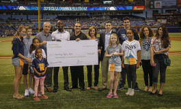 Representatives from Humana present a $350,000 check to Starting Right, Now at a Tampa Bay Rays game