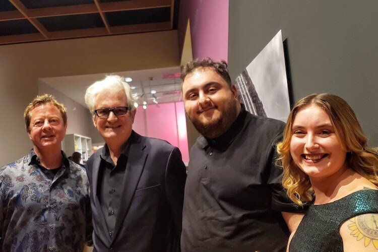 Local art collector Stanton Storer and Yann Weymouth, chief architect of the Dali Museum and the James Museum of Western and Wildlife Art, with USF seniors in Humanities Rami Mohammad and Emily Gregoire.