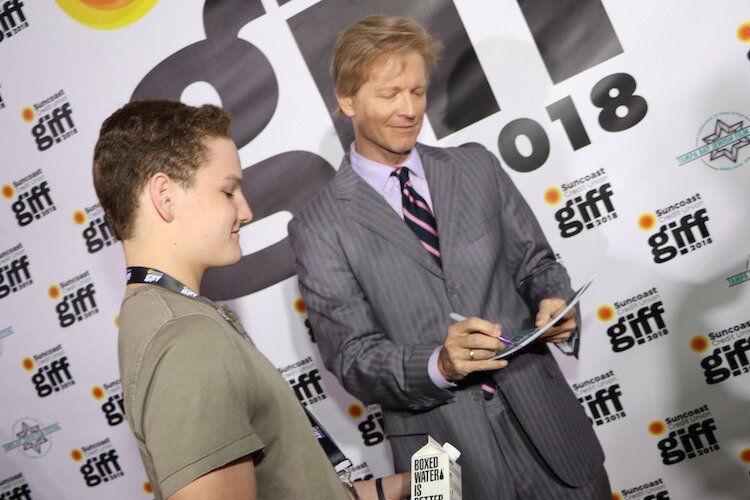 Eric Stoltz autographs memorabilia for a young fan at GIFF 2018.