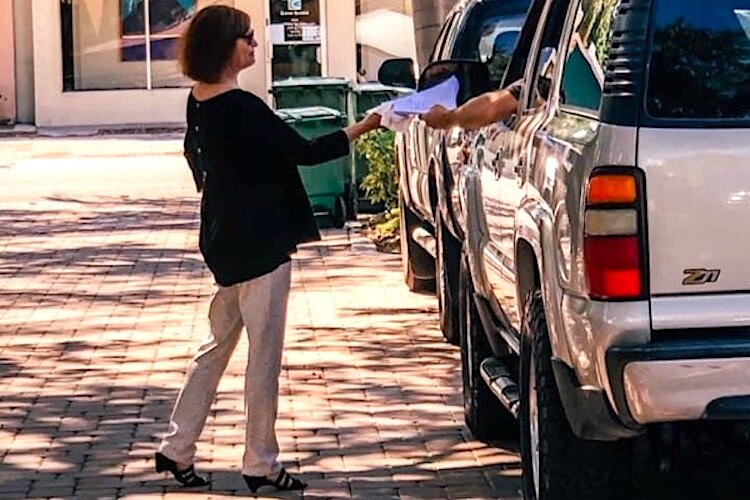 Susan Dennison provides curbside service at Majesty Title in Tampa.