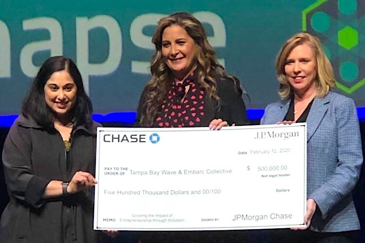 Lakshmi Shenoy of Embarc Collective (left) and Linda Olson of Tampa Bay Wave (right) receive a $500,000 grant from Michele Grace of JPMorgan Chase to launch the TechWomen Rising Accelerator.