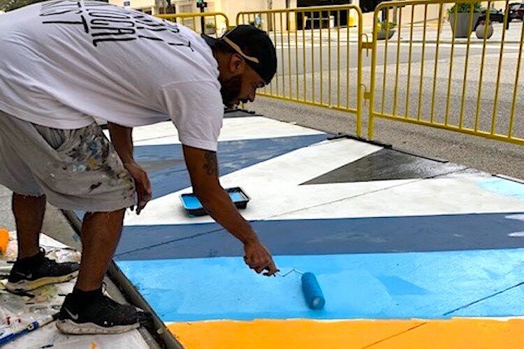 Artist Ron Simmons works his magic to brighten up another parklet.