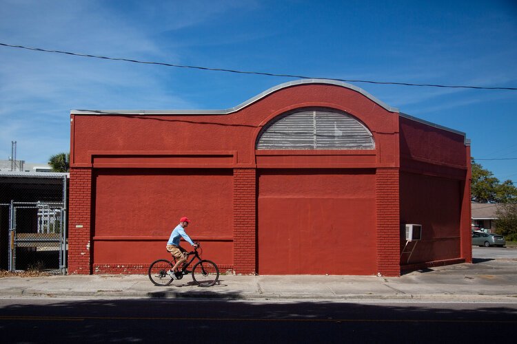 A man cycles down North Fort Harrison in Clearwater where the city plans to put the North Ward Elementary School on the historic registry and give new life to the building.