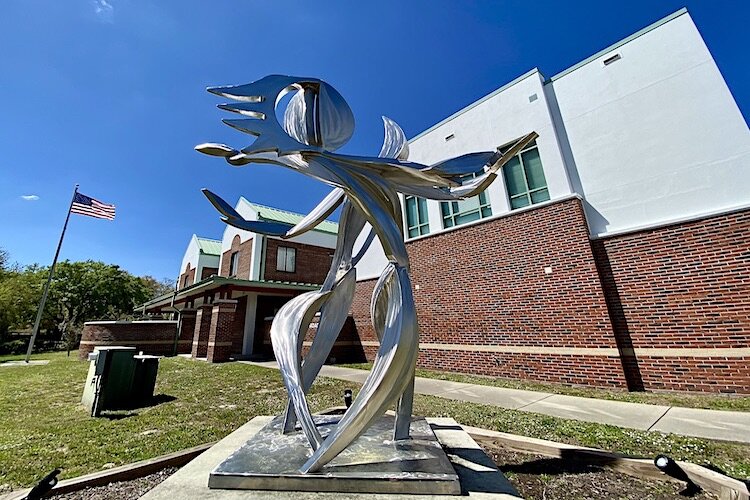 An abstract creation by Chicago artist Michael Young depicts the sun and moon dancing in front of the Carrollwood Cultural Center.
