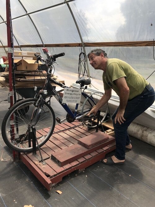 A pedal-powered bicycle generator helps provide energy to the Rosebud greenhouse.