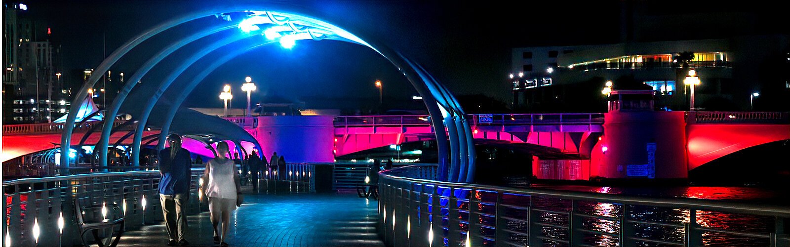 Walking the Tampa Riverwalk is a great choice to connect to the participating venues while enjoying the colorful lighting display on the architecture.