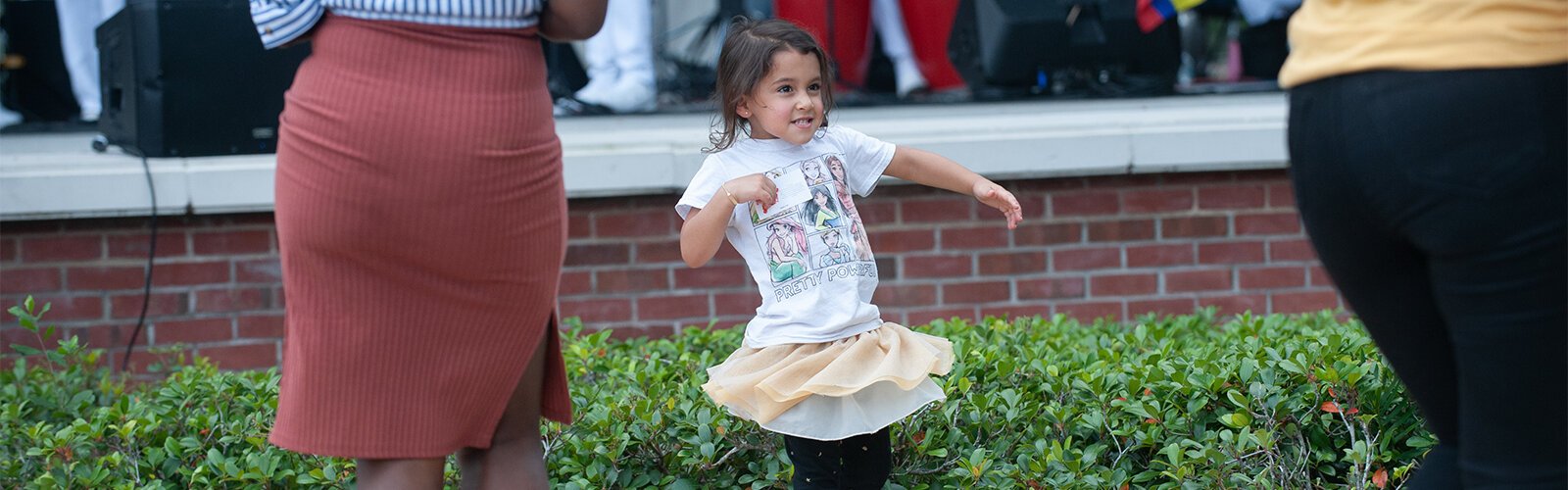 Three-year-old Camila Leon dances with her mother, Angela Leon, in front of the stage at the Multicultural Family Day event at Water Works Park on Sunday in Tampa.