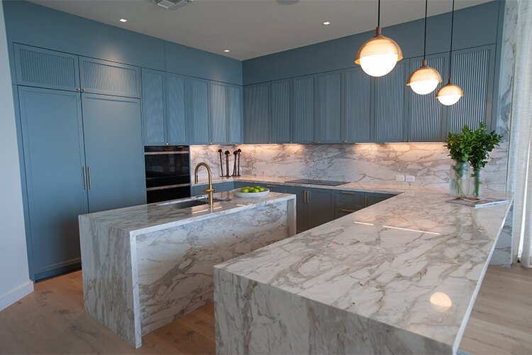 A view of a kitchen with Italian marble counters in a model condo at the sales center for the Residences by Ritz-Carlton at 3101 Bayshore Blvd. The luxury tower and villas are under construction with completion some time in 2024.