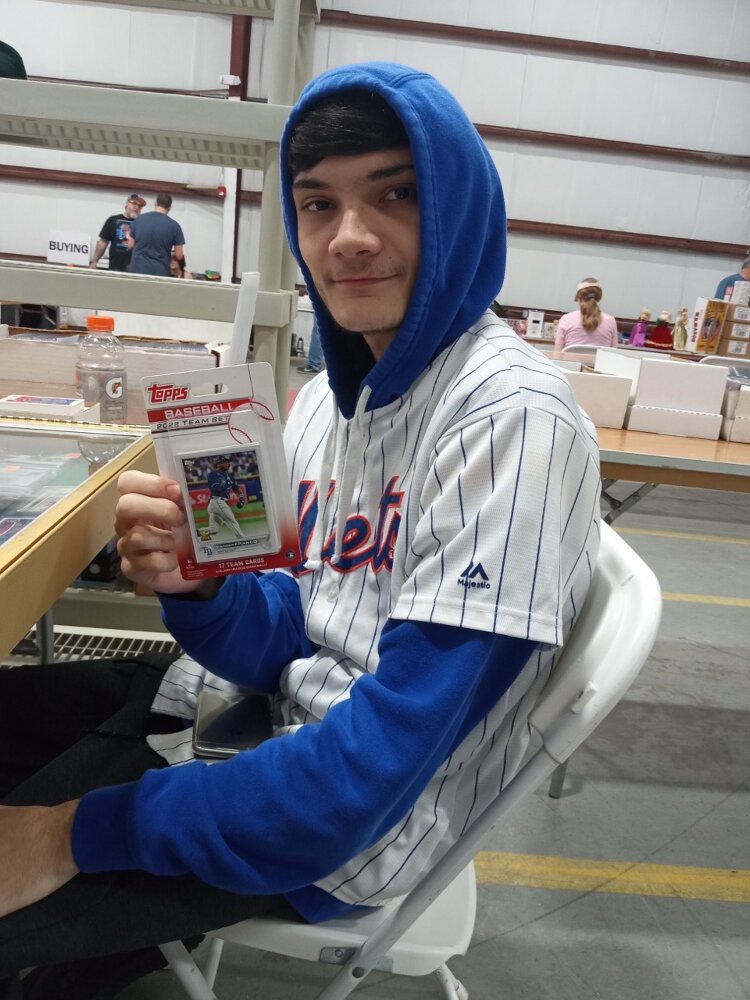 Matt Heyer, of Matt's Cards at the Oldsmar Flea Market, holds up a Tampa Bay Rays Topps team pack featuring a Wander Franco card.