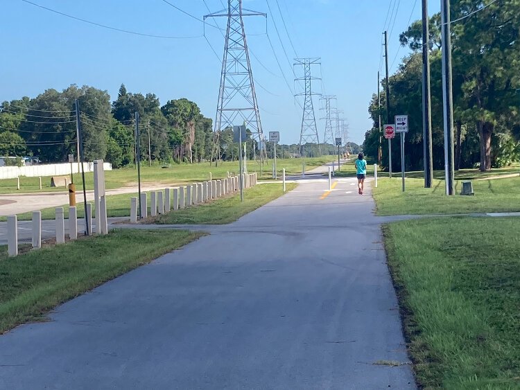 A walker heads down the newly opened Clearwater-Palm Harbor leg of the Pinellas Duke Energy Trail just after an August 5th ribbon-cutting ceremony.