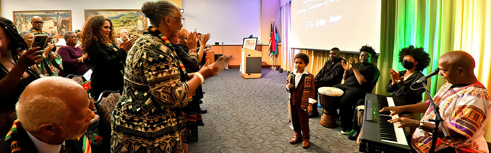 Seven-year-old Avery, a student at the Carlton Burgess School of the Arts, gets a standing ovation after singing two songs about Dr. Martin Luther King Jr. and freedom. He was accompanied on piano by Carlton Burgess.