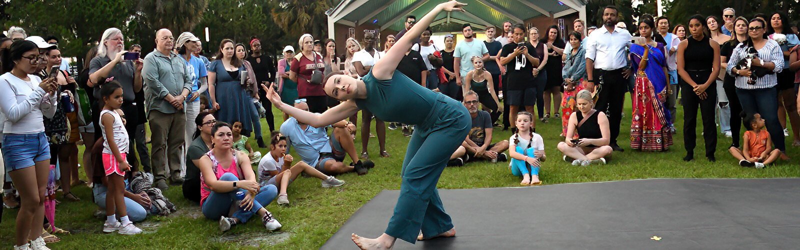The audience watches choreographer Madeleine Wilcox, a 2023 BFA graduate from the USF School of Theatre and Dance, performing “REM” on the grounds of Water Works Park.