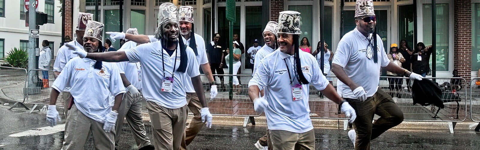 With their red fezes covered for the rain, members of the MISR 213 Marching Club from Accokeek, MD enjoy themselves as they parade with style, embodying the organization philosophy of   having fun while serving.
