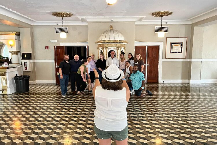 A group on the Ybor City Ghost Tour poses for a photo inside the historic Cuban Club.