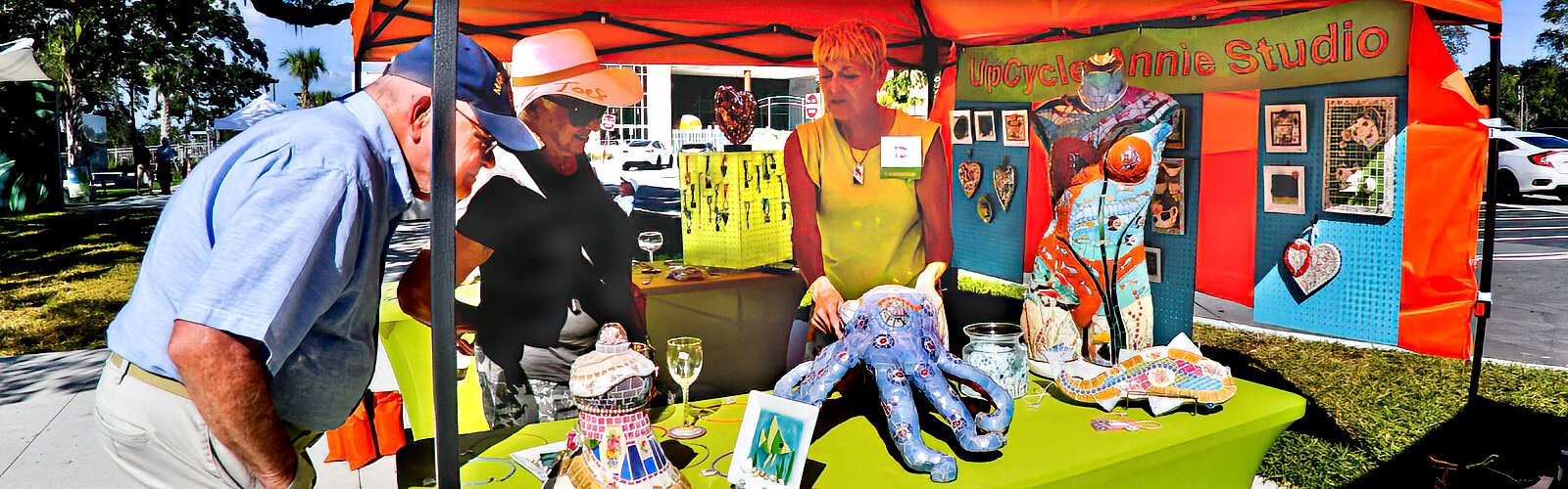 Artist Anne Cao of Upcycle Annie Studio explains to interested shoppers how she created and decorated with mosaics her octopus, a one-of-a-kind and submersible art piece. 