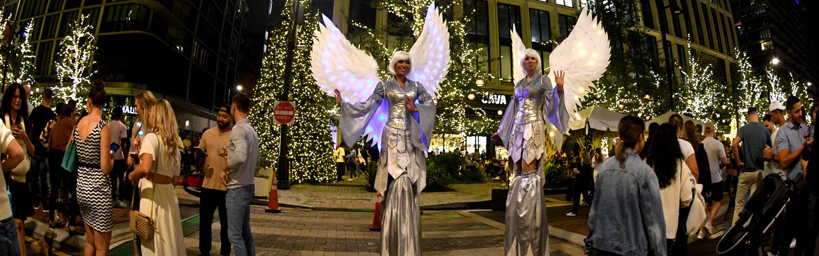 Another beautiful set of angels on stilts mingle with the crowd at Water Street Tampa during the Season Spectacular.