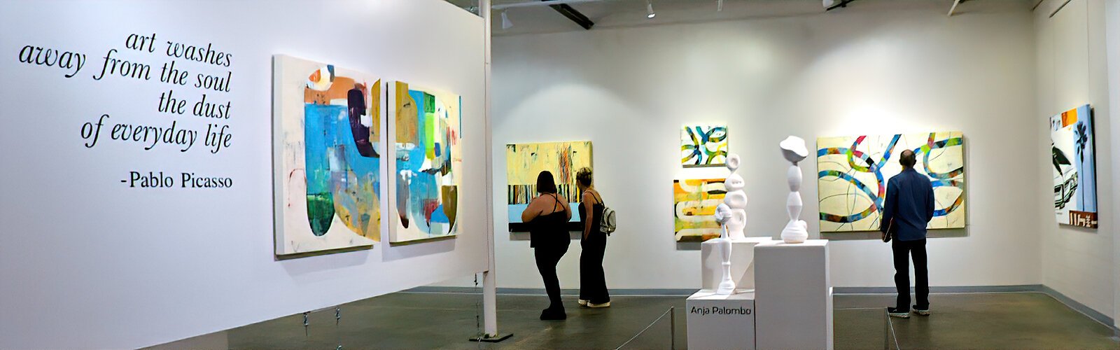 Visitors admire artwork at the Soft Water Gallery on the ArtsXchange campus during the Second Saturday ArtWalk.