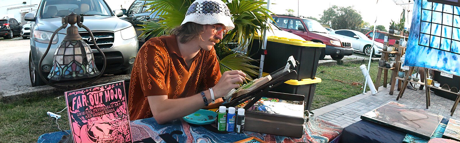  Alec Ward of Far Out Mojo works on a new piece in his outdoor booth at the ArtsXchange campus during the Second Saturday ArtWalk.